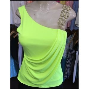 Top with golden accessorie on one shoulder